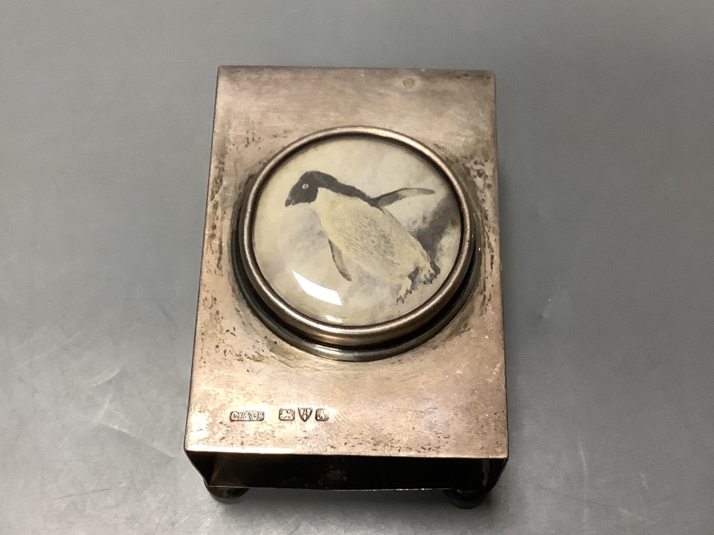 A George V silver mounted cut glass inkwell, goldsmiths and silversmiths Co Ltd, London 1914, 11.4cm and a silver matchbox sleeve.